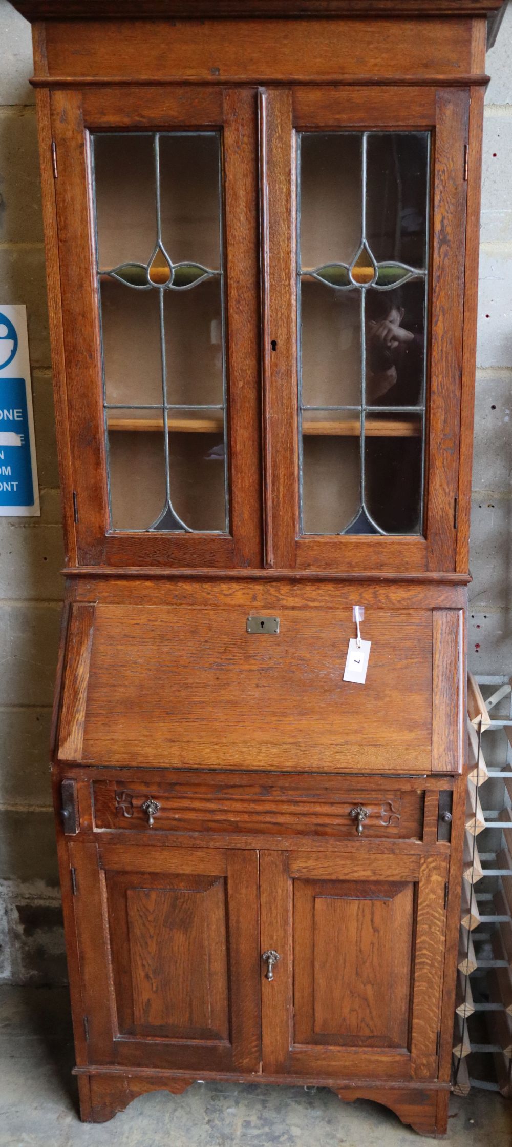 An Edwardian Arts & Crafts oak bureau bookcase, width 70cm, depth 34cm, height 196cm